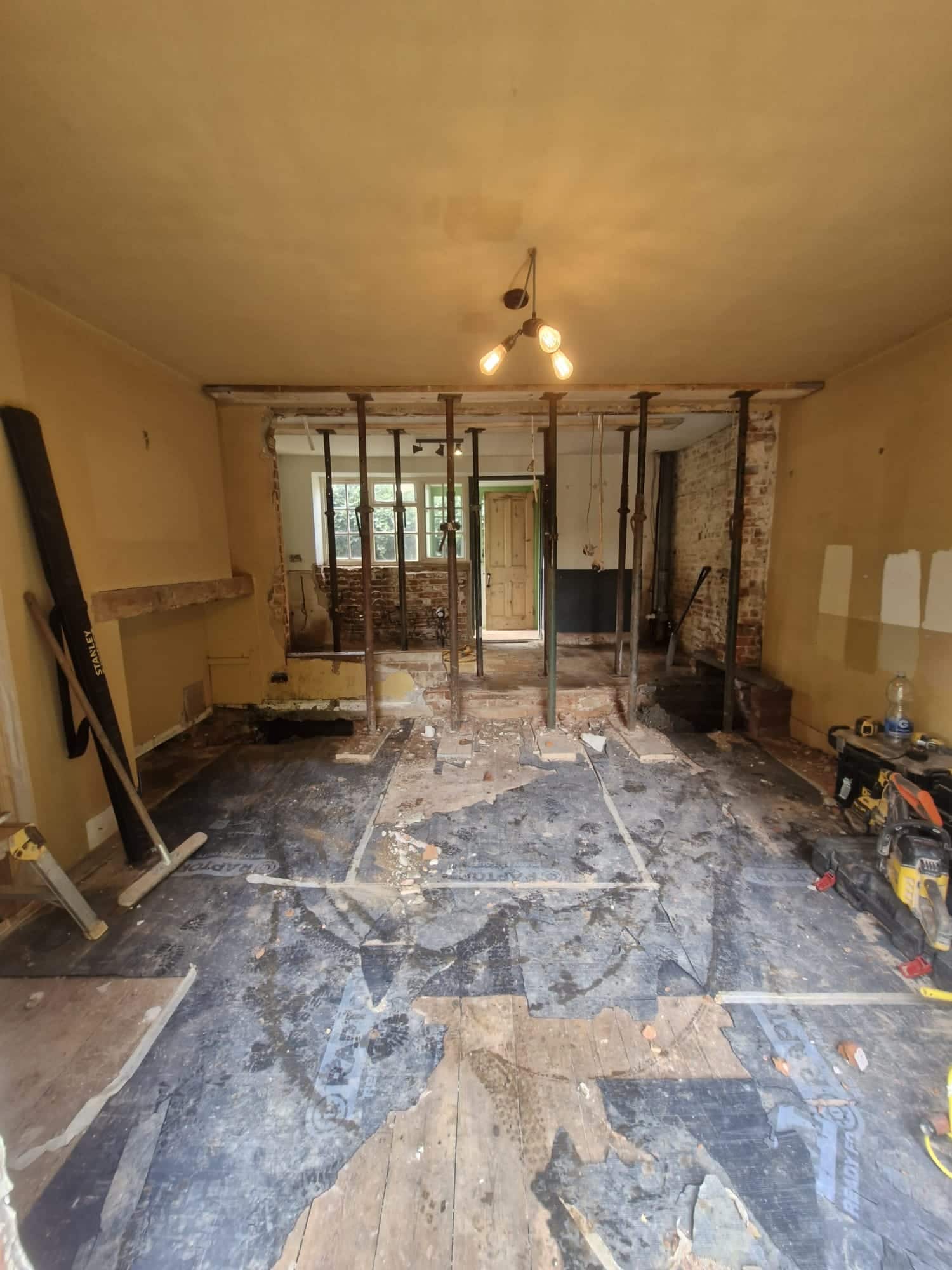 Steel beam supported on Acrow props during a knock-through between two rooms in a period house