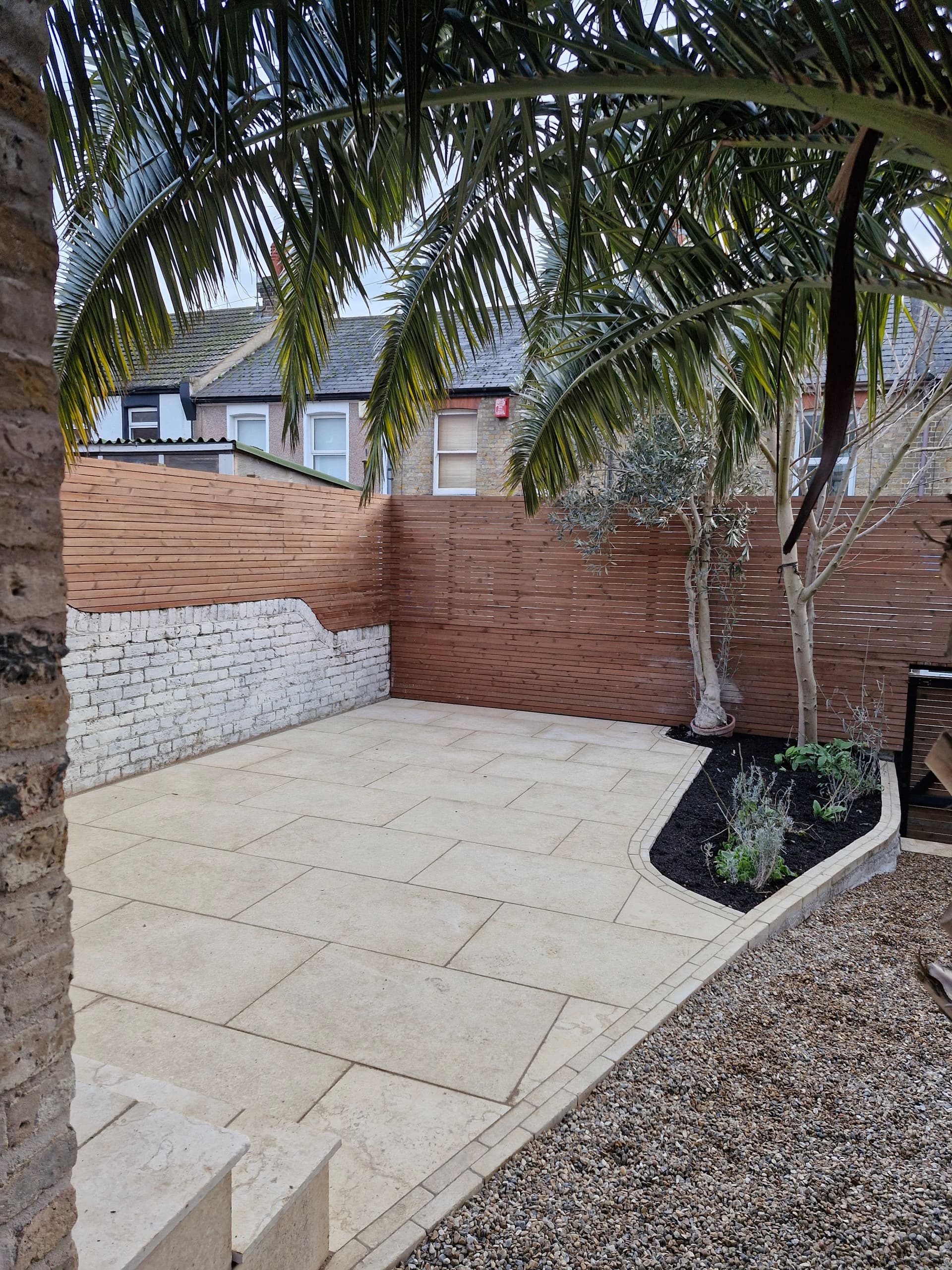 Bespoke garden with palm tree and stone paving